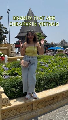 a woman standing in front of a flower garden with the words brands that are cheaper in vietnam