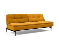 an orange couch sitting on top of a white floor