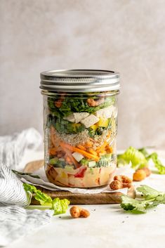 a mason jar filled with vegetables and nuts