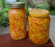 two jars filled with food sitting on top of a table