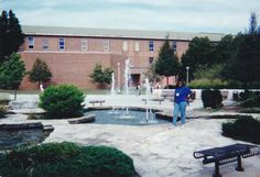 a person standing in front of a fountain