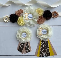 two giraffes and flowers are attached to ribbons