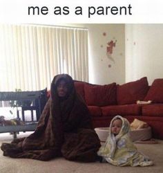 a child wrapped in a blanket sitting on the floor next to a couch with text that reads, me as a parent