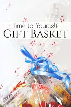 a basket filled with candy and candies on top of a white table next to the words time to yourself gift basket