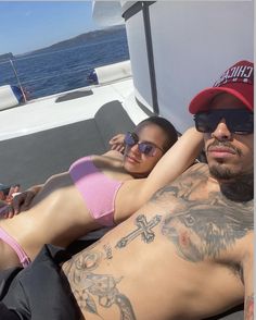 a man and woman laying on top of a boat