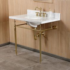 a bathroom sink sitting under a mirror next to a wall