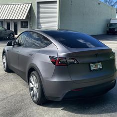 an electric car parked in front of a building