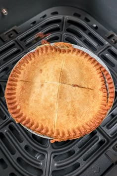 an uncooked pie sitting on top of the grill