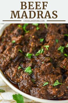 beef madras in a white bowl with cilantro garnish on top