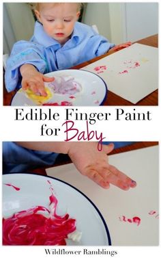 a toddler is painting with red and white paint on his hands while sitting at a table