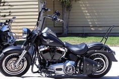 a black motorcycle parked in front of a house