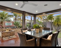 an outdoor dining area with table and chairs