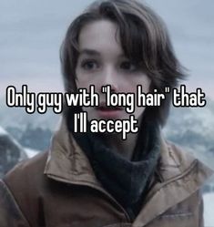 a girl with long hair that is looking at the camera and has her face covered in snow