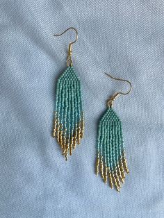 In stock. Going soon. Small Aqua & 24K Gold Ombré Beaded Fringe Earrings only at $25.0.. #FringeBeadEarrings #GiftsForHer #BeadedEarrings #BohoChicEarrings #GoldDangleEarrings #TrendyEarrings #BeadedLightweight #HippieEarrings #HandmadeEarrings #StatementJewelry Diy Thread Earrings, Fringe Earring Pattern, Mint Green Jewelry, Small Fringe, Fringe Beaded Earrings, Fringe Earring, Mint And Gold, Tiffany Earrings, Loom Bracelet Patterns