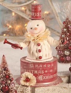 a snowman figurine on top of a tin can