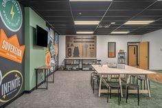 a room with tables, chairs and signs on the wall