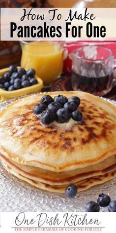 pancakes with blueberries and syrup are on a plate, ready to be eaten for breakfast