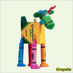 an animal made out of crayons and some other items in the shape of a cow