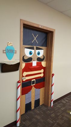 a door decorated with a nutcracker and candy canes