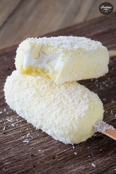 two pieces of cake sitting on top of a wooden cutting board