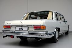 an old mercedes benz is parked in a garage