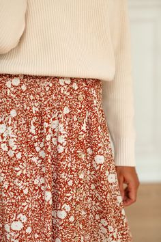 A crowd-favorite is back in a new color – the 'Shauna' maxi skirt is here! Featured in a beautiful rust color and adorned in florals, this maxi skirt is the epitome of charm and beauty. The smocked waist creates a flattering and comfortable fit! Pair with a chunky sweater and low ankle boots for a playful yet sophisticated fall ensemble. Exclusively designed by us with you in mind! 100% Polyester Unlined Hand Wash Cold Separately Hang or Lay Flat to Dry Do Not Bleach Do Not Dry Clean Iron Low He Spring Maxi Skirt With Smocked Back, Spring Skirt With Smocked Back, Flowy Maxi Skirt With Smocked Back, Flowy Tiered Maxi Skirt With Smocked Back, Spring Long Skirt With Smocked Bodice, Bohemian Skirt With Smocked Bodice And Flowy Fit, Bohemian Skirt With Smocked Bodice And Flowy Cut, Bohemian Skirt With Smocked Back, Fall Maxi Skirt With Elastic Waistband