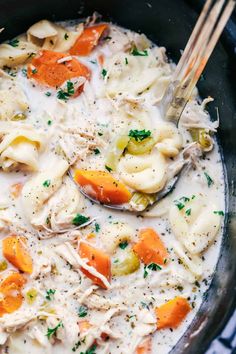 a bowl filled with dumplings and carrots