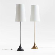 two black and gold lamps with white shades on each lamp, one is turned off