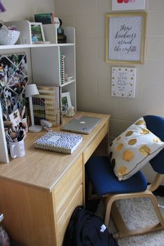 a desk with a chair, bookshelf and pictures on the wall