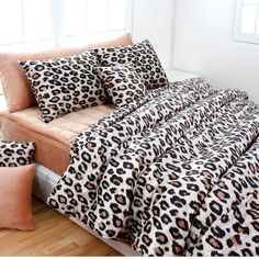 a leopard print bed spread with matching pillows