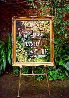 an easel with a sign on it that says return to the wedding of david and kate