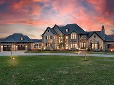 a large house with lots of windows and lights