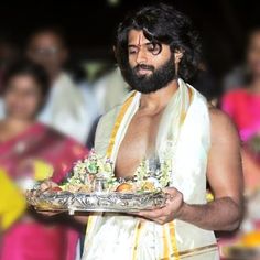 a man with a beard holding a platter