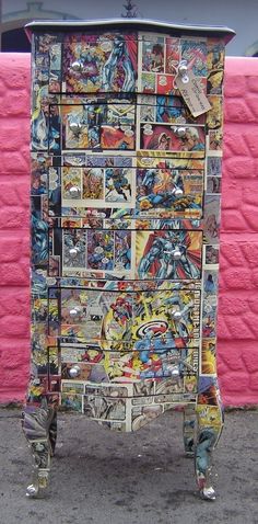 an old dresser is covered with comic books