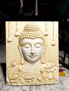 a white buddha statue sitting on top of a table