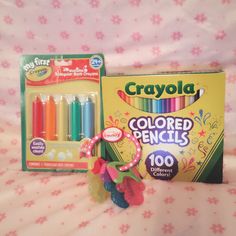 crayola colored pencils are sitting on a bed