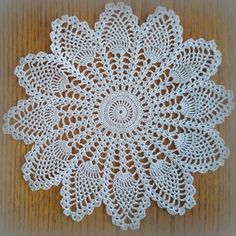 a white doily on a wooden surface