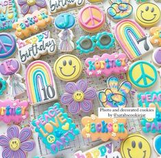 there are many decorated cookies with happy birthday written on them and smiley faces in the middle