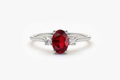 "Ruby Ring / Ruby Engagement Ring in 14k Gold / Oval Cut Natural 3 Stone Ruby Diamond Ring / July Birthstone / Promise Ring by Ferkos Fine Jewelry Features ✔Made to Order ✔Gold Kt: 14K (also available in 18K) ✔Available Gold Color: Rose Gold, Yellow Gold, White Gold ✔Oval Ruby: 1 pc 6x4MM ✔Round Diamond: 2 pcs 2.0 MM ✔Number of Stones: 3 ✔Ruby CTW: 0.70 ctw ✔Diamond CTW: 0.07 ctw ✔Ready to Ship in 7-10 Business Days If you have any additional questions about this ring, just hit the \"Ask a Quest Oval Three Stone Ruby Ring With Diamonds, Oval Ruby Ring With Three Diamonds, Classic Oval Three-stone Birthstone Ring, Classic Oval Three Stone Birthstone Ring, Formal Oval Three Stone Birthstone Ring, Oval Three Stone Birthstone Ring For Formal Occasions, Classic Oval Ruby Ring In 14k White Gold, Oval Three-stone Ruby Promise Ring, Oval Three Stone Ruby Ring For Wedding