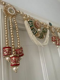 the beaded garland is hanging from the ceiling with pearls and other beads on it