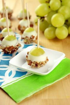 some food is sitting on a plate with grapes in the background and an ad for grape poppers