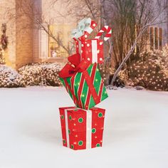 two wrapped presents sitting on top of each other in the snow