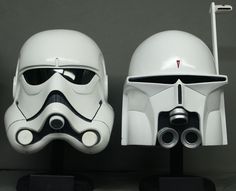 two star wars helmets sitting next to each other