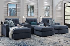 a living room filled with blue furniture and pillows on top of it's covers