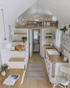 the interior of a tiny home with stairs leading up to it