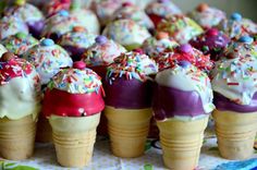 there are many ice cream cones with sprinkles on them