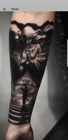 a man's leg with a black and white tattoo design on it, which has an image of a person standing in front of a gate