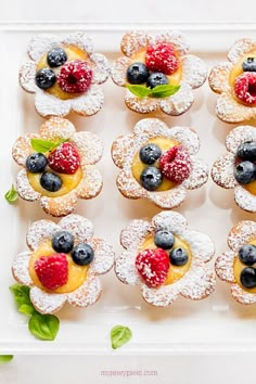 small pastries with berries and blueberries on them