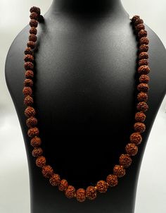 Immerse yourself in the sacred energy of our meticulously crafted Rudraksha Mala featuring 7mm beads. Handcrafted from authentic Rudraksha seeds, each bead carries a rich history of spiritual significance. Rudraksha beads are revered for their ability to enhance meditation, promote mindfulness, and attract positive energies. Key Features: Authentic Rudraksha Seeds: Sourced with care, each 7mm bead is a genuine Rudraksha seed, known for its powerful spiritual vibrations. Meticulous Craftsmanship: Our Rudraksha Mala is handcrafted with precision, ensuring the integrity of each bead and the overall aesthetic appeal of the necklace. Versatile Meditation Aid: The 7mm bead size strikes a perfect balance, making this mala ideal for both beginners and experienced practitioners. Use it for meditati Spiritual Necklaces With 108 Beads For Rituals, Spiritual Necklaces With 8mm Beads For Rituals, Holistic Jewelry With 108 Beads For Rituals, Holistic Necklaces With 8mm Beads For Rituals, 8mm Spiritual Beads For Meditation, Handmade Spiritual Mala, Spiritual Gemstone Beads Necklace For Rituals, Spiritual Gemstone Beads For Rituals, Spiritual Beaded Necklaces With Gemstone Beads For Rituals