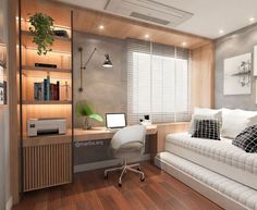 a white couch sitting next to a desk in a room with wooden floors and walls